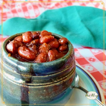 cup of cooked beans with text overlay "pressure cooker baked beans