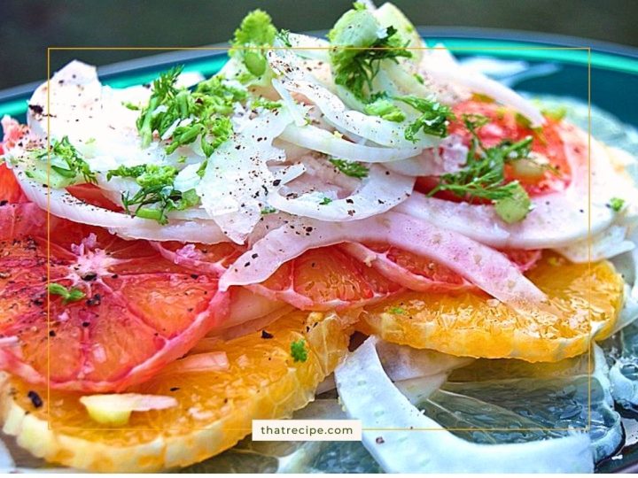 slices of orange topped with sliced fennel bulb and fronds