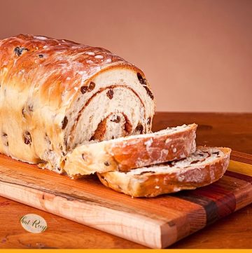 loaf of cinnamon swirl raisin bread on a cutting board