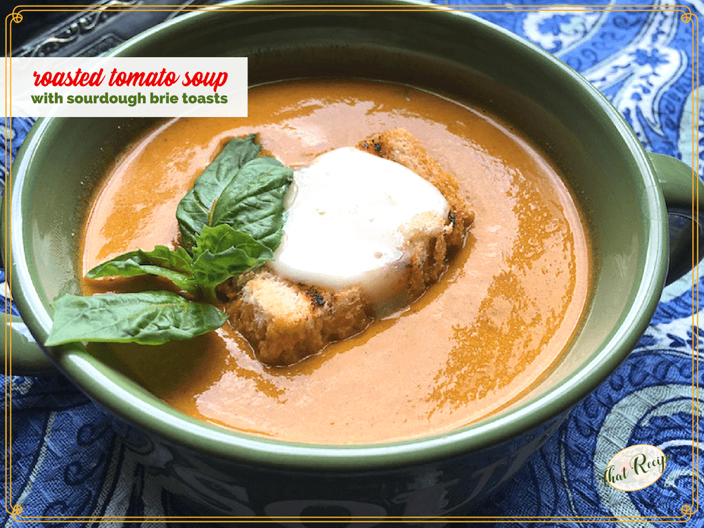 bowl of tomato soup with fresh basil and sourdough brie toast on top