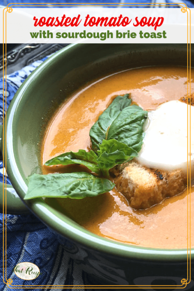 bowl of tomato soup with fresh basil and sourdough brie toast on top