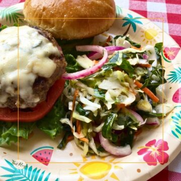 Cole slaw and burger on a plate
