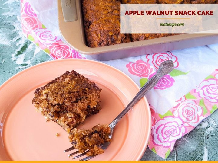 slice of cake on a plate with text overlay "apple walnut snack cake"