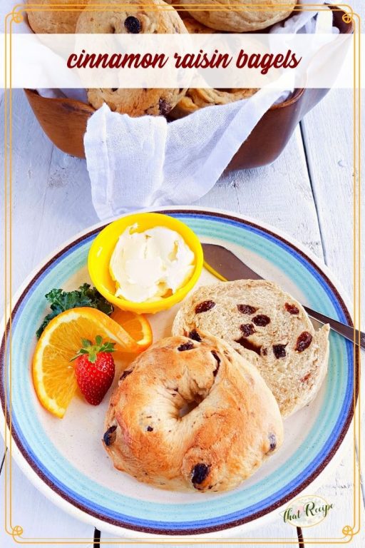 homemade bagel on a plate with fruit and cream cheese and text overlay "cinnamon raisin bagels"