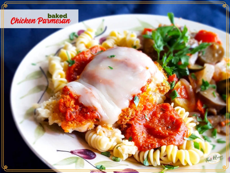 baked chicken parmesan on a plate with pasta and vegetables