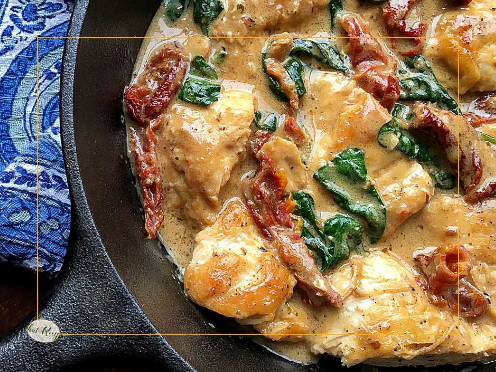 Creamy Tuscan Chicken in cast iron skillet.