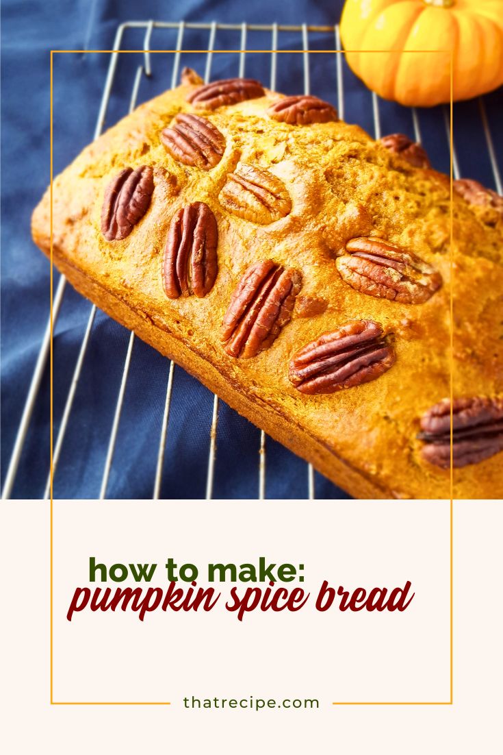 loaf of pumpkin spice bread on cooling rack with mini pumpkin