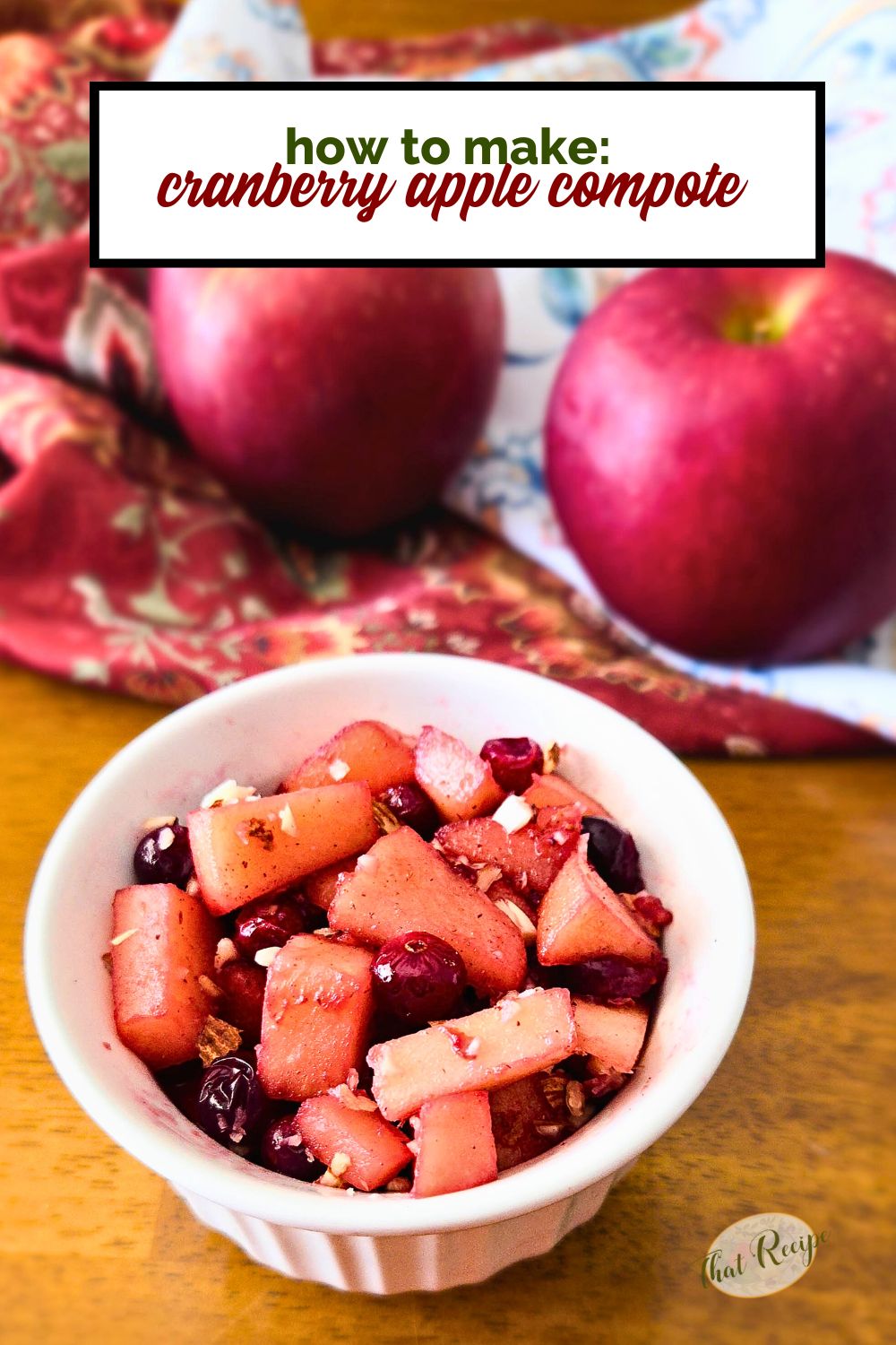 cranberry apple compote in a cup with fresh apples