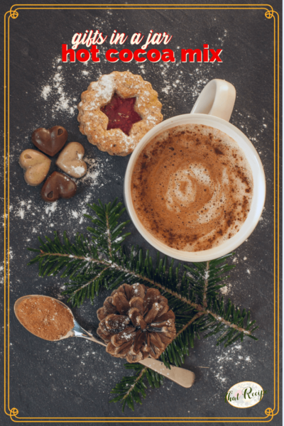 top down view of mug of hot cocoa with cookies with text overlay "Gifts in a Jar: Hot Cocoa Mix"