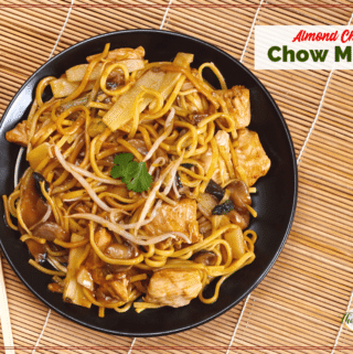 chow mein on a black plate with chopsticks on a bamboo mat with text overlay Almond Chicken chow mein