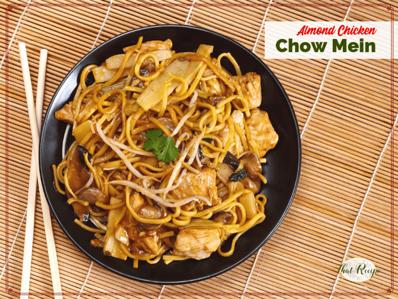 chow mein on a black plate with chopsticks on a bamboo mat with text overlay Almond Chicken chow mein