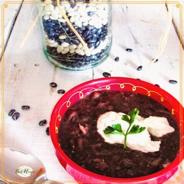 bowl of black bean soup with text overlay "gifts in a jar spicy black bean soup"