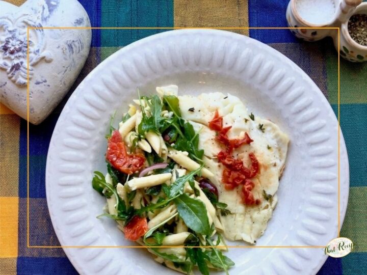 top down view of fish and pasta salad on a plate with top inset of fish in foil packet