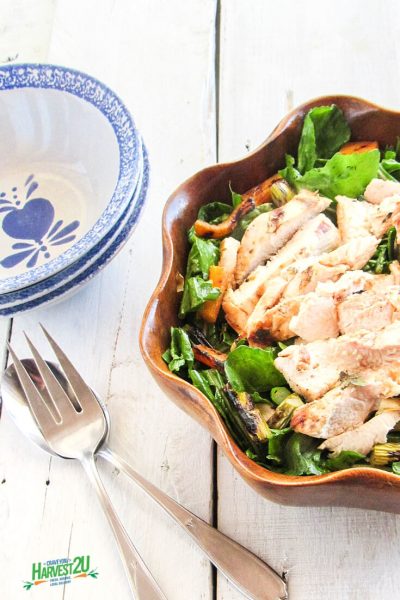 grilled chicken salad in a wooden bowl
