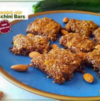 zucchini bars on a plate with almonds and text overlay "chocolate chip zucchini bars"