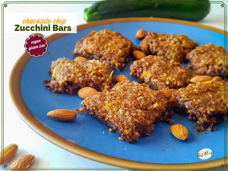zucchini bars on a plate with almonds and text overlay "chocolate chip zucchini bars"