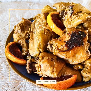 plate of cooked chicken pieces with blood orange slices