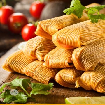 stacked chicken tamales on a board