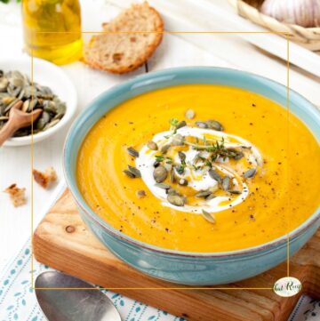 pumpkin soup topped with yogurt and pumpkin seeds