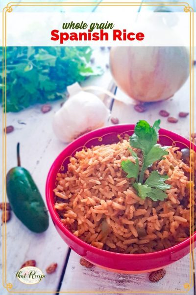 spanish rice in a bowl on the table with onion pepper and cilantro