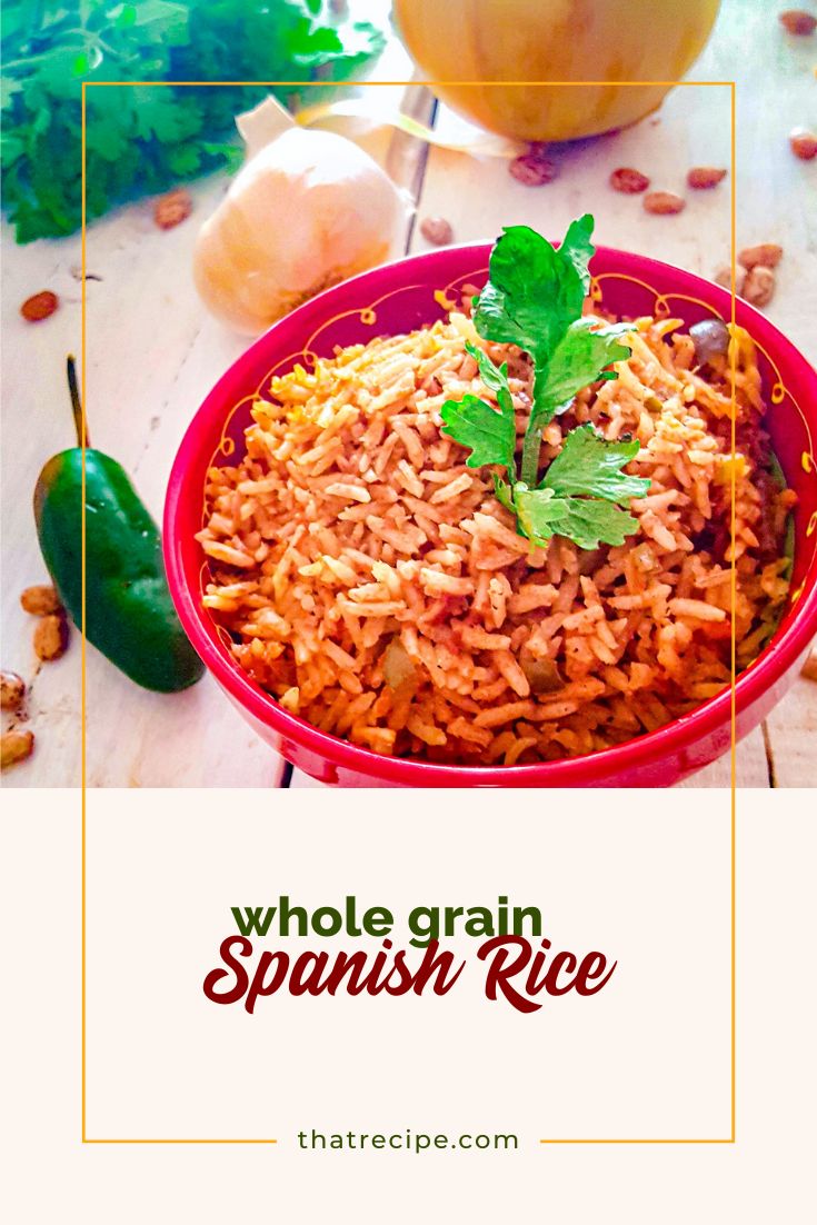 spanish rice in a bowl on the table with onion pepper and cilantro