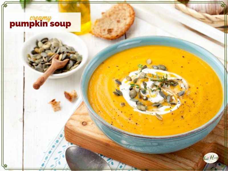 pumpkin soup topped with yogurt and pumpkin seeds