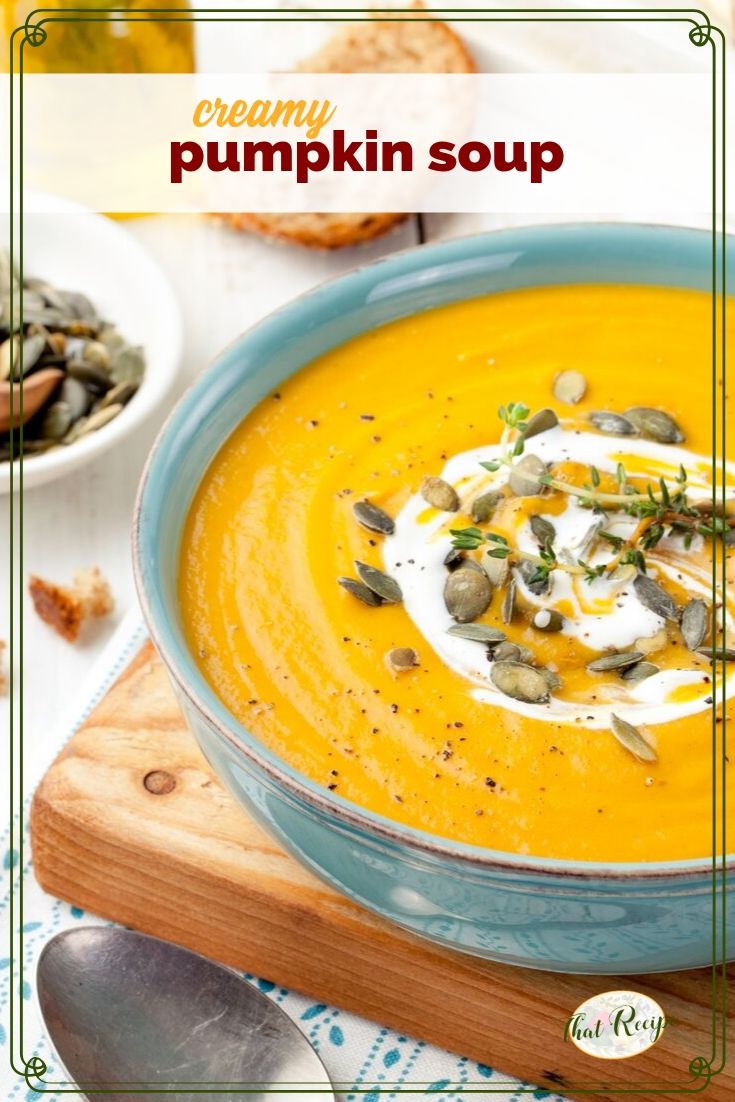 pumpkin soup topped with yogurt and pumpkin seeds