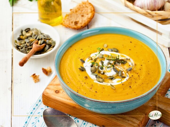 pumpkin soup topped with yogurt and pumpkin seeds