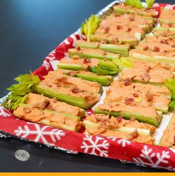 tray of stuffed celery with text overlay "Bacon Bloody Mary Stuffed Celery"