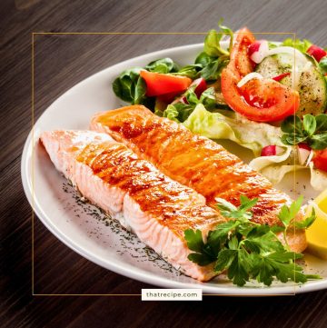 roasted salmon on a plate with a salad