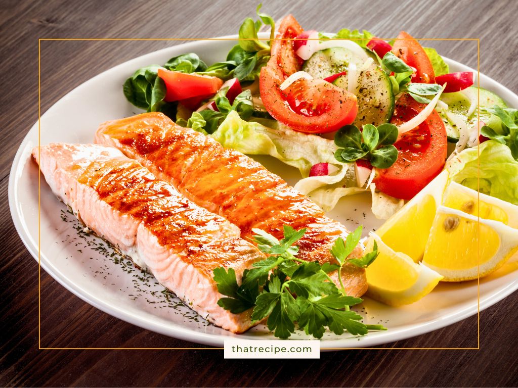 roasted salmon on a plate with a salad