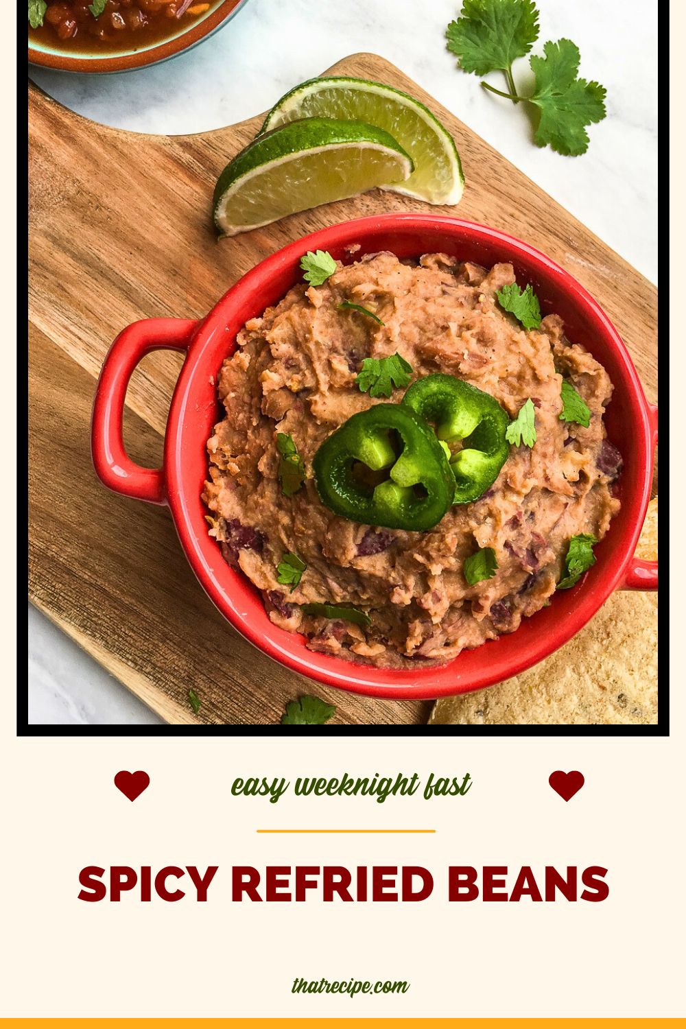 bowl of refried beans on a chopping block with limes
