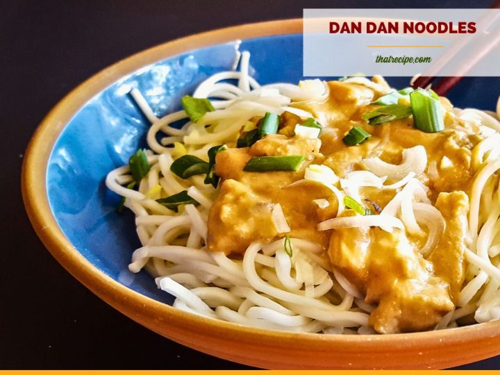 bowl of chicken and sauce over noodles with text overlay "Dan Dan Noodles with chicken"