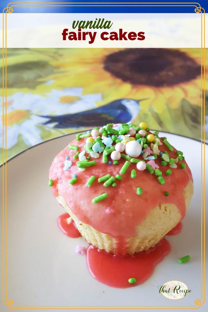 cupcake with sprinkles on a plate with text overlay "vanilla fairy cakes"