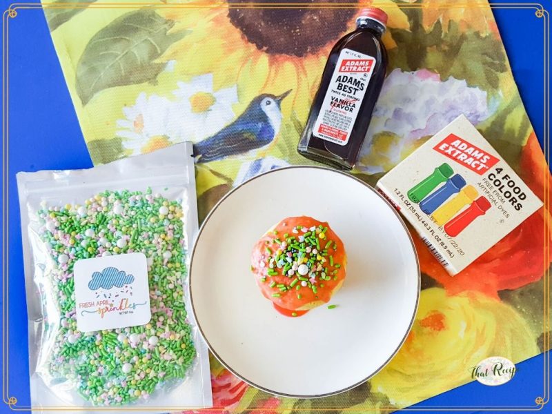 cupcake with sprinkles on a plate with text overlay "vanilla fairy cakes"