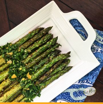 cooked asparagus on a plate with text overlay "grilled asparagus with fresh gremolata"