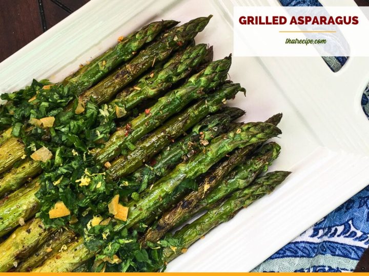 cooked asparagus on a plate with text overlay "grilled asparagus with fresh gremolata"