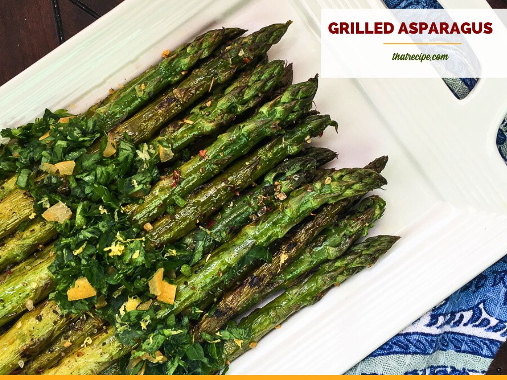 cooked asparagus on a plate with text overlay "grilled asparagus with fresh gremolata"