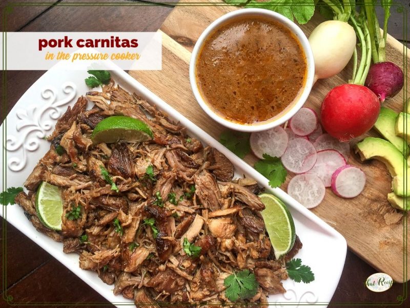 plate of pork carnitas with sauce and vegetables on the side.