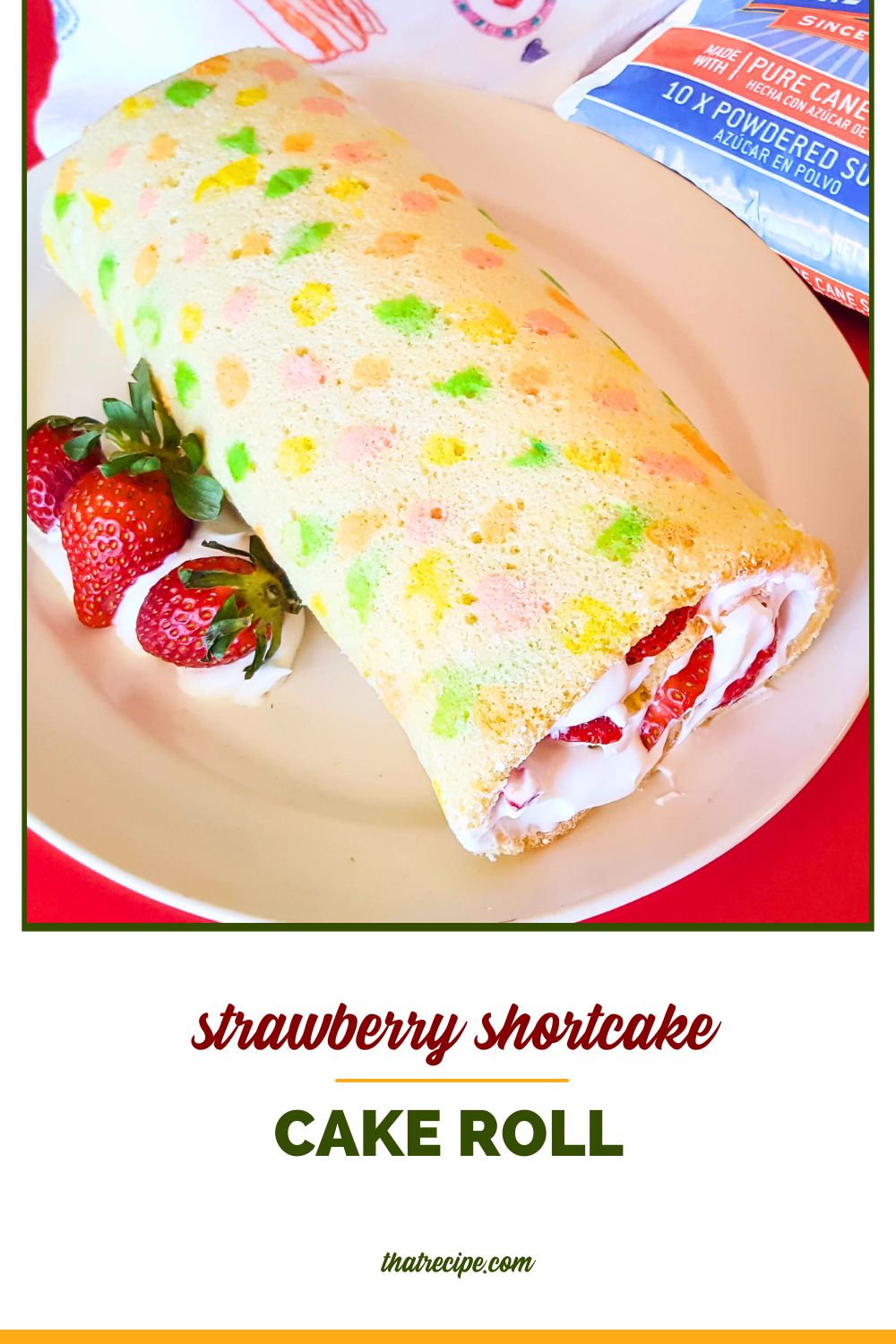 vanilla swiss cake roll with strawberries and whipped cream with text overlay "strawberry shortcake cake roll"