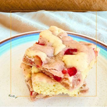 strawberry cream cheese swirl cookie bars on a plate