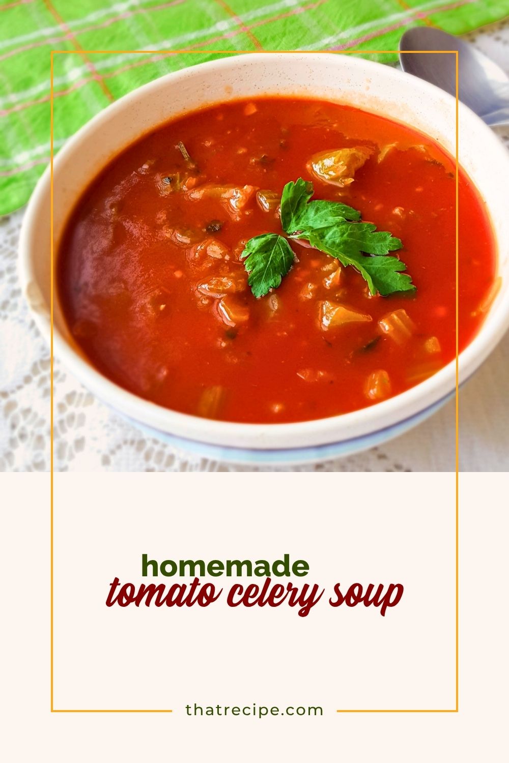 overhead view of tomato and celery soup in a bowl with a spoon