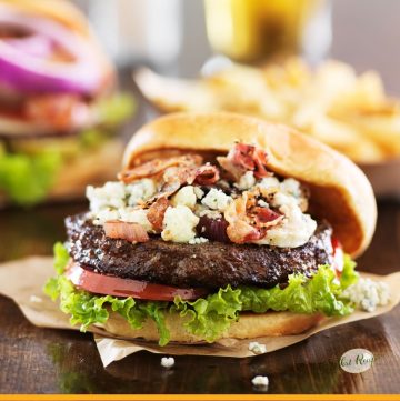 bacon and blue cheese burger on a table with fries
