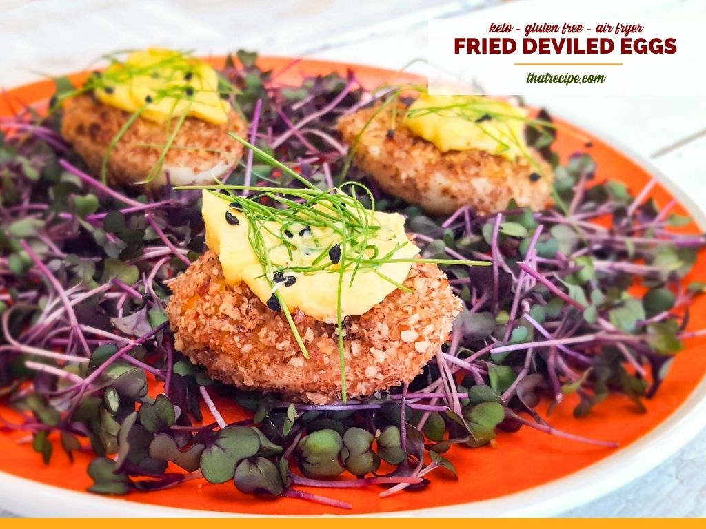 fried deviled eggs on bed of microgreens with text overlay "keto air fried deviled eggs"