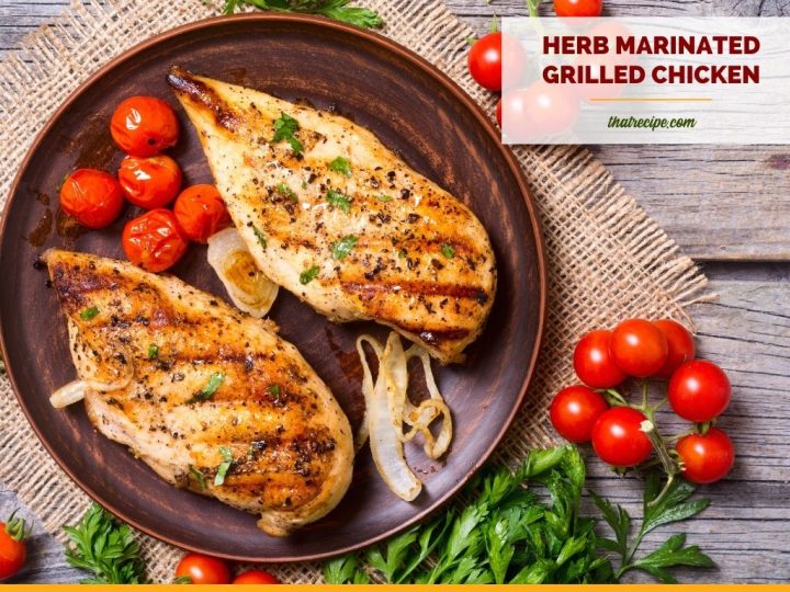 grilled chicken on a plate with text overlay herb marinated chicken