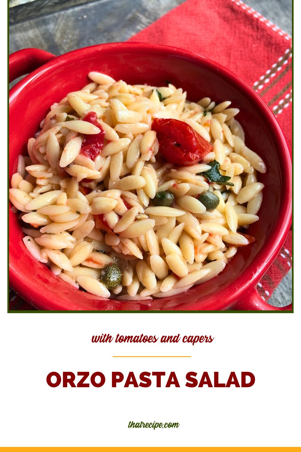 orzo pasta salad in a red bowl on blue slate with text overlay "orzo pasta salad with tomatoes and capers"