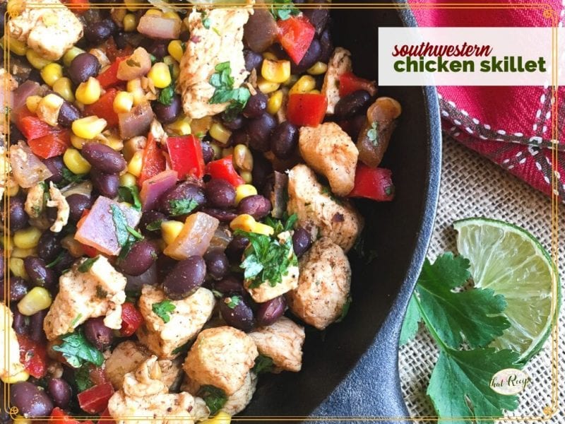 close up of cast iron skillet with chicken and black bean stir fry and text overlay "southwestern chicken skillet"