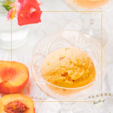 bowl of peach frozen yogurt and fresh peaches