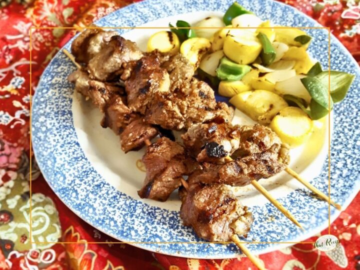 grilled beef shish kebabs on a plate with grilled vegetables