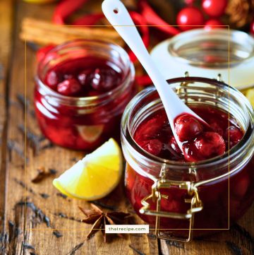 jars of cherry chutney with lemon slices, cherries and cinnamon